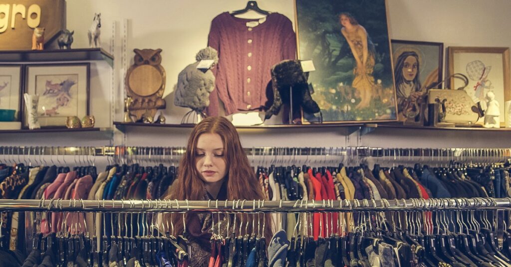 bored woman cleaning out her closet