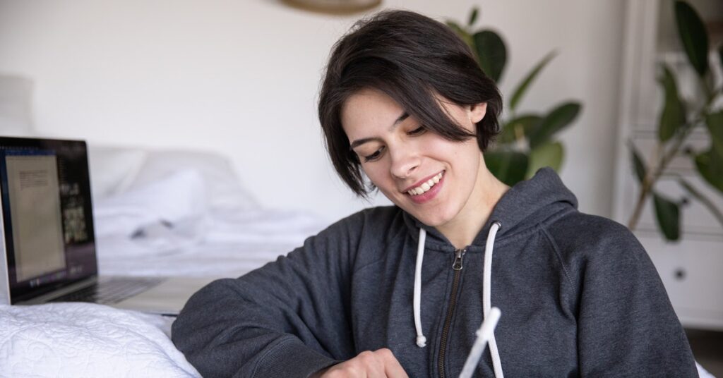 woman writing in a journal during social distancing