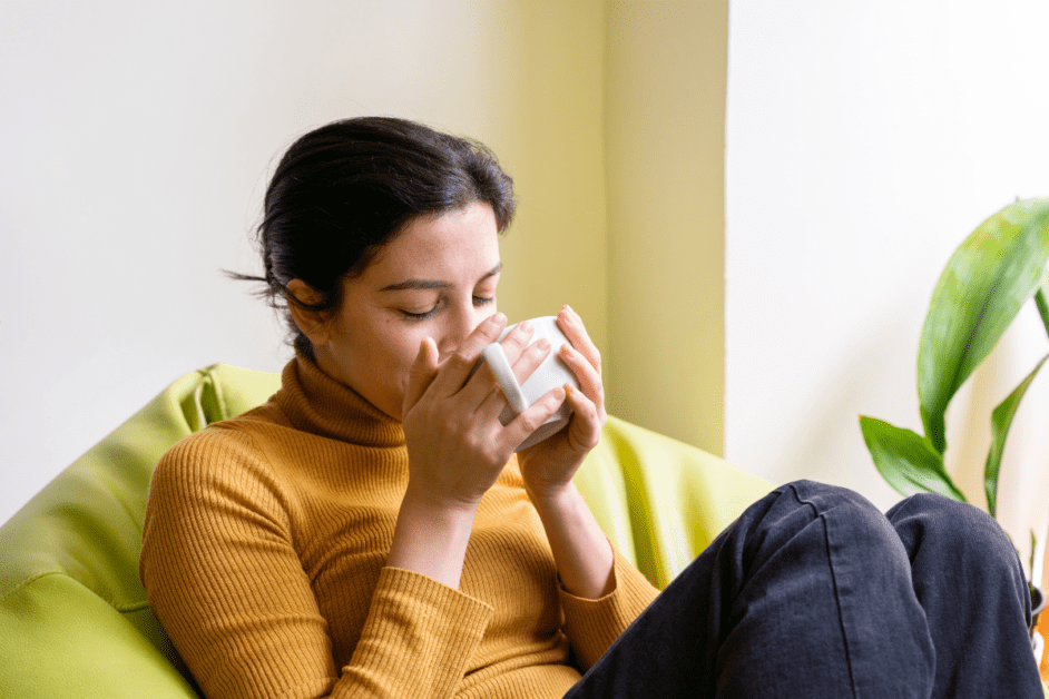 Woman drinking tea for bloating